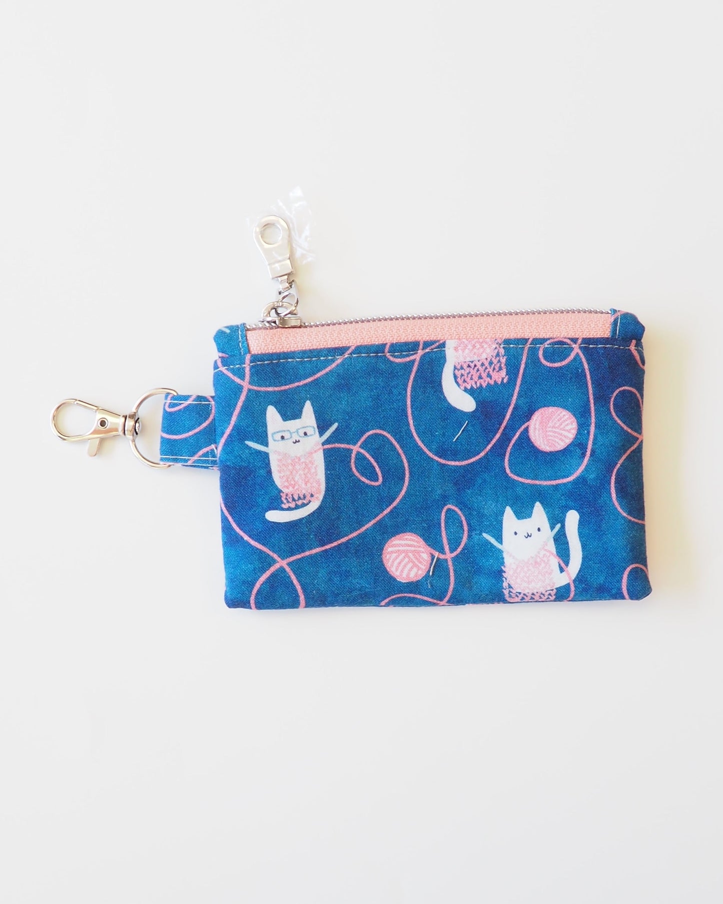 Small blue pouch with cat pattern on a white background