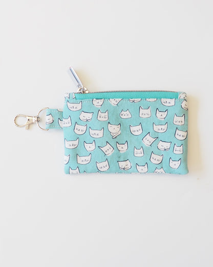 Small blue pouch with white cat pattern on a light gray background