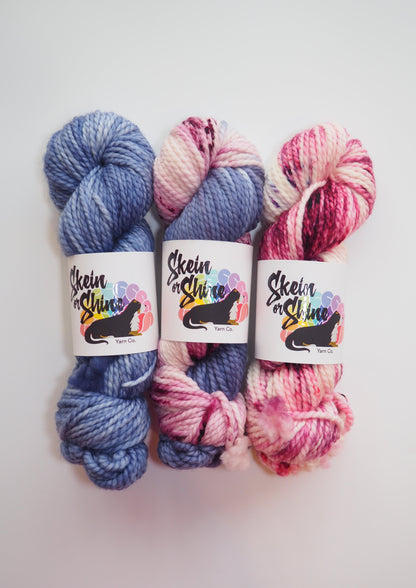 image of three skeins of skein or shine bulky, one navy, one infinity, one good grief.