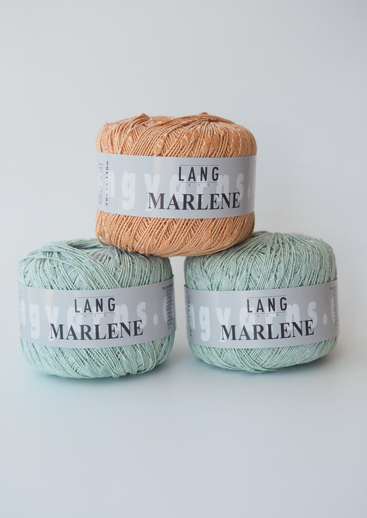 image of 3 balls of Lang Marlene yarn. Two mint and one soft orange. All three have grey labels around the ball of yarn.