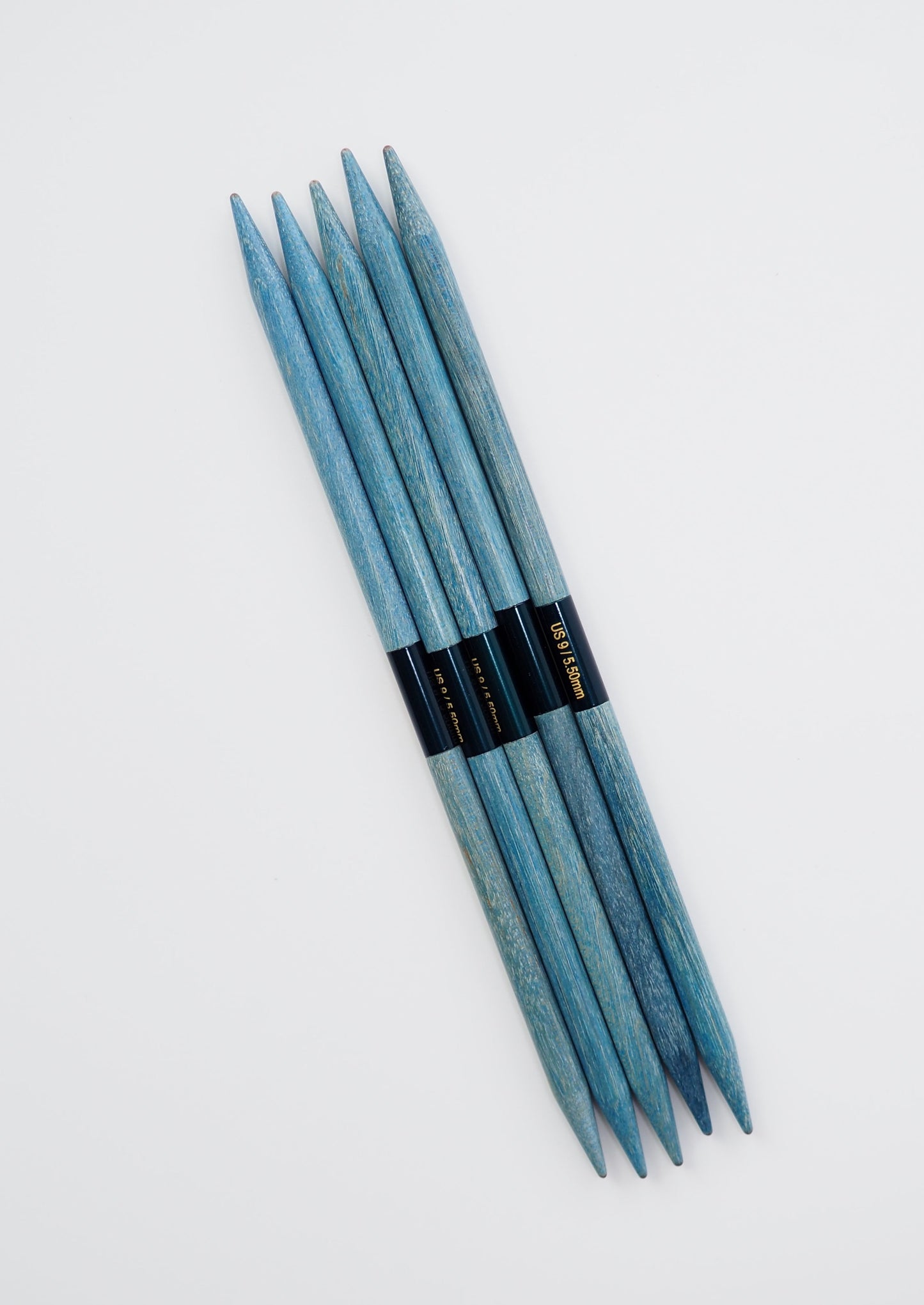 an image of "Lykke Indigo 6" Double Pointed Needles". the images shows 5 blue wooden double pointed needles in size 5.5mm against a white background
