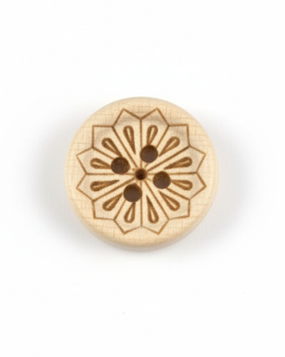 Decorative wooden button with intricate design on a plain background