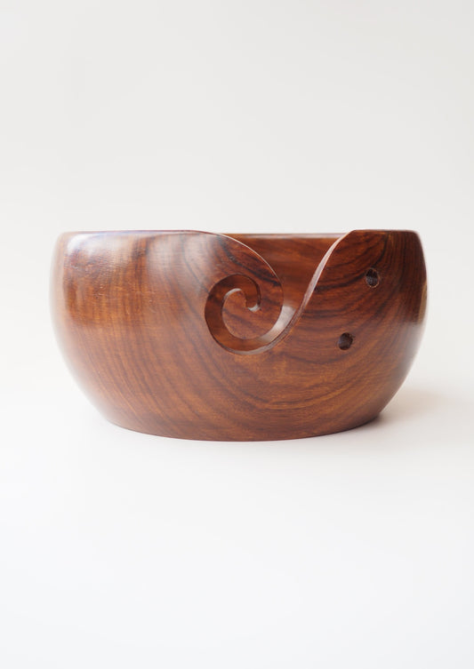 Estelle Yarn Bowl - Acacia Curvy: Handcrafted Acacia wood bowl with yarn guide and needle rest holes. Smooth finish. Measures approx. 8"x4"