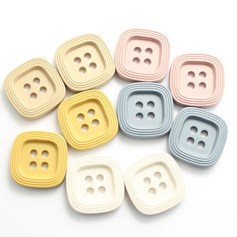 an image of square resin buttons 18mm in the colours pink, blue, white, beige and yellow