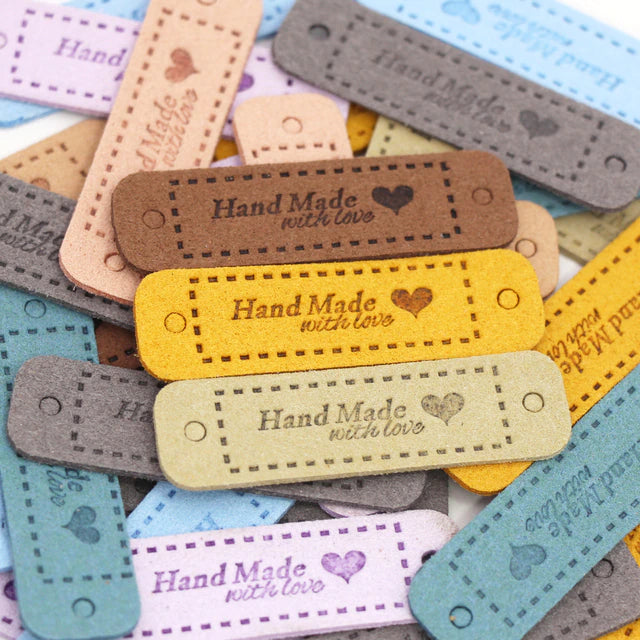 an image with faux leather rectangular labels that say "handmade with love" which a heart beside the text