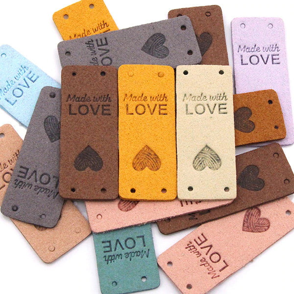 an image with faux leather rectangular labels that say "made with love" with an upside down heart below the text.