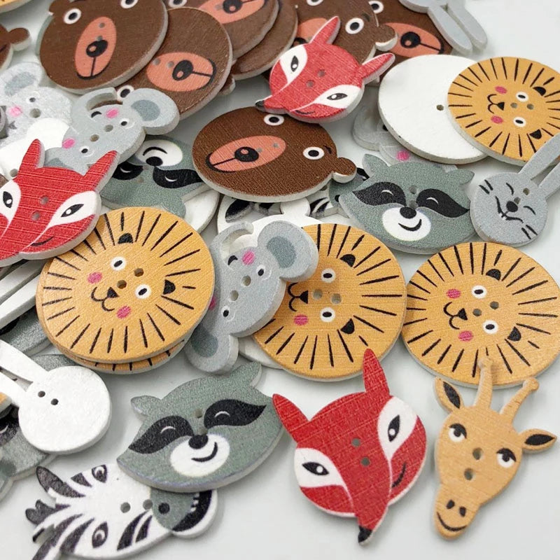 image of animal shaped wood buttons. animals include lions, foxes, racoons, giraffes, bears, bunnies, and elephants