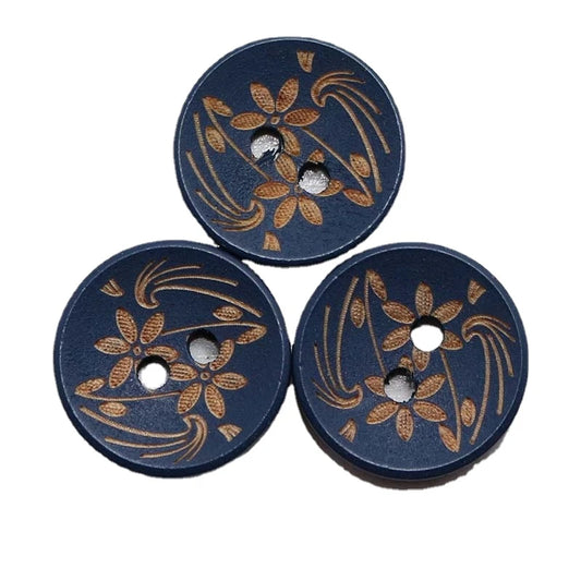 an image of three blue wood buttons with floral carvings. the carvings are brown