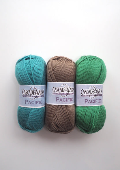 an image of three balls of Cascade Pacific Yarn. one turquoise, one brown, one green